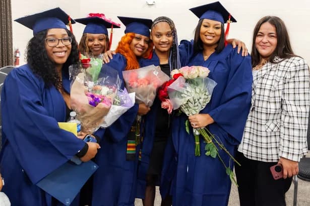 SCC graduates celebrating with flowers